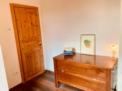 a room with a wooden dresser and a door at primiero-suite 45mq in Transacqua