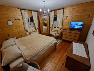 a bedroom with a bed and a television in it at Appartamento Lorena in Rocca Pietore