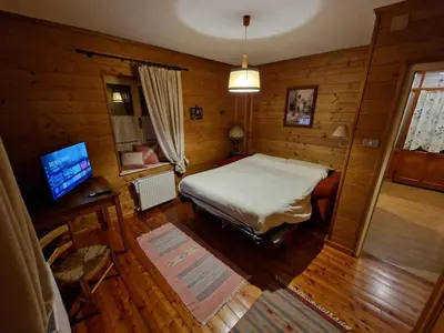 a bedroom with a bed and a desk and a television at Appartamento Lorena in Rocca Pietore