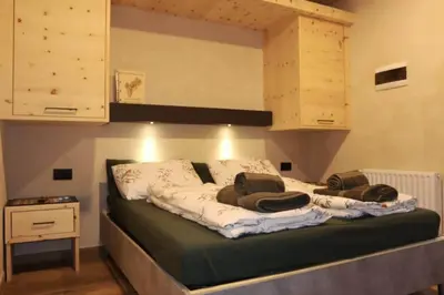 a bed in a room with a loft bed at Ciesa Le Crepedele - Miniappartamento Zirum in Sottoguda