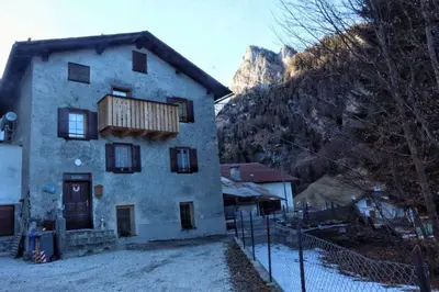 a house with a balcony on the side of it at Ciesa Le Crepedele - Miniappartamento Zirum in Sottoguda