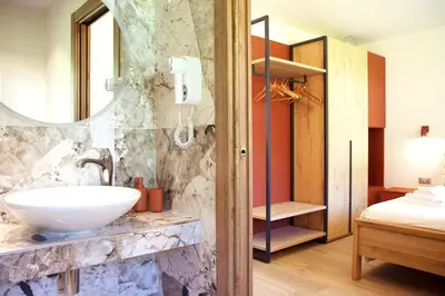 a bathroom with a sink and a mirror at Villa Re Laurino Suite Respiro del bosco in Moena