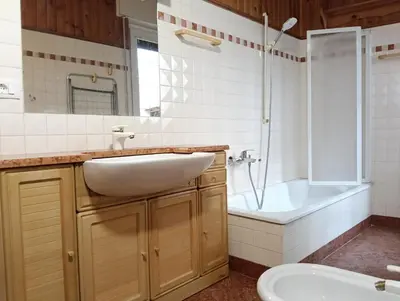 a bathroom with a sink and a tub and a toilet at Werner's in Castello di Fiemme