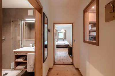 a bathroom with a hallway leading to a bedroom at Resciesa Hof in Ortisei