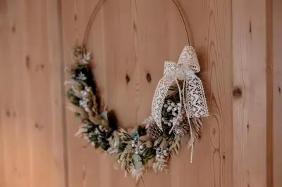 a wreath is hanging on a wooden wall at Resciesa Hof in Ortisei