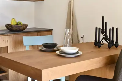 a wooden table with two bowls and plates on it at Apartments Mitterhof 1544 in Brunico