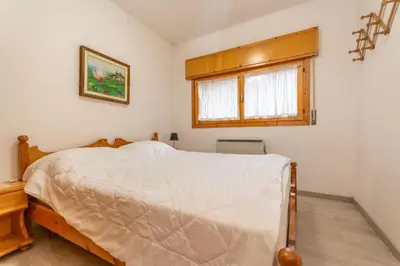 a bedroom with a bed and a window at Appartamento Cordevole PT in Caprile