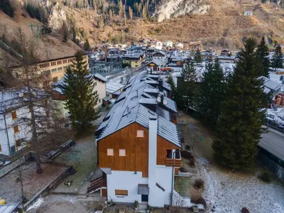an aerial view of a town with houses and mountains at Appartamento Cordevole PT in Caprile