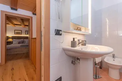 a bathroom with a sink and a toilet at Chalet Dolomiti - Camp - Alpine Eco stay in Vallalta