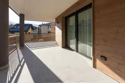 a balcony of a house with a wooden wall at Vacanze la Malga in Predazzo