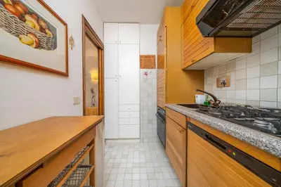a kitchen with a sink and a counter top at Le Gemelle Apartment in Cortina dʼAmpezzo
