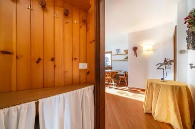 a room with a table and a dining room at Le Gemelle Apartment in Cortina dʼAmpezzo