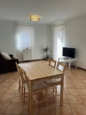 a wooden table and chairs in a living room at Al Monte Zelo in Agordo