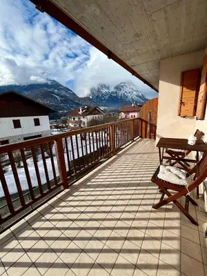 a balcony with a bench and a view of mountains at Al Monte Zelo in Agordo