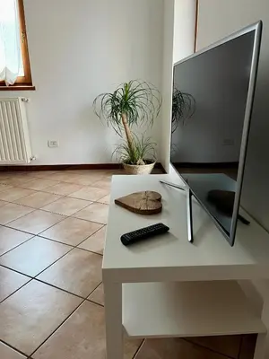 a desk with a computer monitor and a keyboard on it at Al Monte Zelo in Agordo
