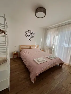 a bedroom with a bed with a pink blanket at Al Monte Zelo in Agordo