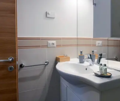a bathroom with a sink and a mirror at Dolomiti Nest in Tesero