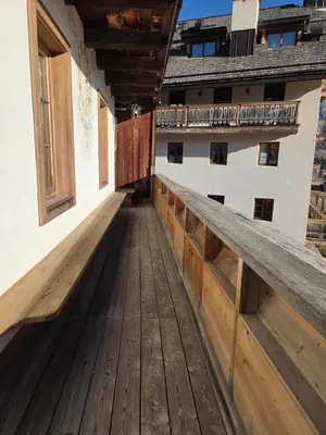 an empty balcony of a house with wooden flooring at Meleres 11 in Cortina dʼAmpezzo