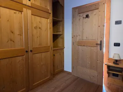 a room with wooden cabinets and a door at Meleres 11 in Cortina dʼAmpezzo