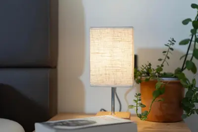a lamp sitting on a table next to a keyboard at Modern apartment with mountain views in Chiusa