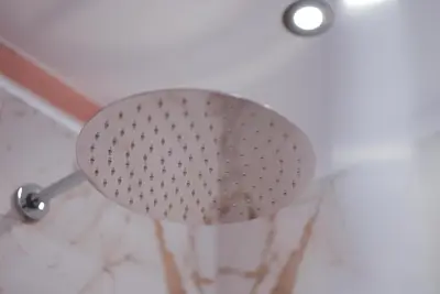 a shower head on top of a white wall at Modern apartment with mountain views in Chiusa