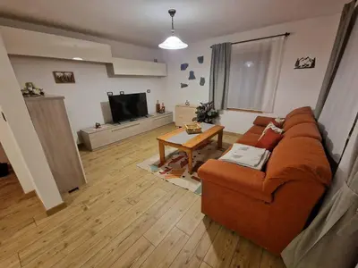 a living room with a couch and a table at Appartamento Federico in Rocca Pietore