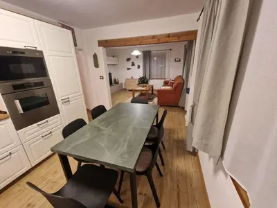 a kitchen and dining room with a table and chairs at Appartamento Federico in Rocca Pietore
