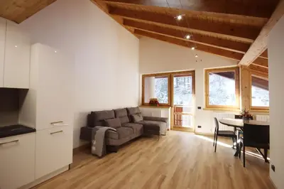 a living room with a couch and a table at Penthouse with view 2 bedrooms free parking in Cortina dʼAmpezzo