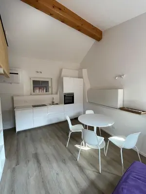 a kitchen and dining room with a table and chairs at Casetta in centro storico in Bedollo