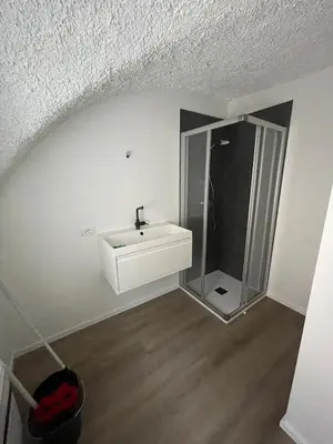 a bathroom with a sink and a glass shower at Casetta in centro storico in Bedollo