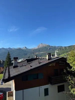 a roof of a house with mountains in the background at Casa Faloria in Cortina dʼAmpezzo