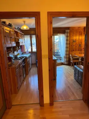 a bathroom with a sink and a toilet and a window at Casa Faloria in Cortina dʼAmpezzo