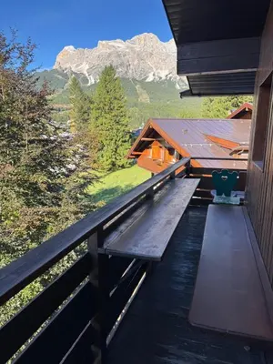 a kitchen with wooden cabinets and a counter top at Casa Faloria in Cortina dʼAmpezzo