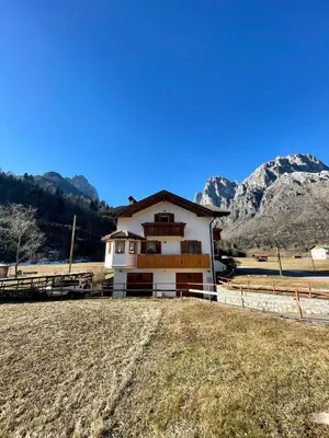 a house on a hill with mountains in the background at Casa Marilu' in Taibon