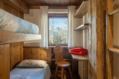 a bedroom with a bunk bed and a window at Apartment Capriol by My Villa Collection in Cortina dʼAmpezzo