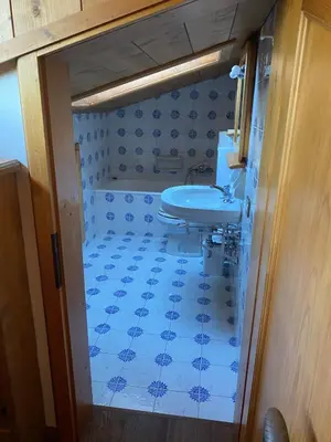 a bathroom with a sink and a blue tiled floor at 360-degree panoramic attic in Cortina in Cortina dʼAmpezzo