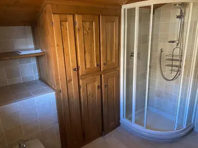 a bathroom with a shower and a glass shower stall at 360-degree panoramic attic in Cortina in Cortina dʼAmpezzo