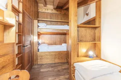 a small room with two bunk beds in it at Casa Funivia 2, with panoramic balcony in Cortina dʼAmpezzo