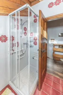 a shower with a glass door in a bathroom at Casa Funivia 2, with panoramic balcony in Cortina dʼAmpezzo