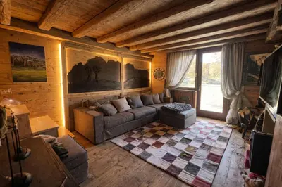 a living room with a couch and a table at Ca Dei Nani - Exclusive stay with sauna in Cortina dʼAmpezzo