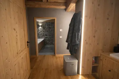 a bathroom with a tub and a toilet in a room at Ca Dei Nani - Exclusive stay with sauna in Cortina dʼAmpezzo