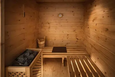a wooden sauna with a bench in it at Ca Dei Nani - Exclusive stay with sauna in Cortina dʼAmpezzo