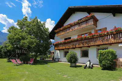a house with flowers on the side of it at Appartements Weisshauserhof in Appiano sulla Strada del Vino