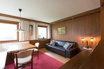 a living room with a couch and a table at Apartments Meisules in Ortisei
