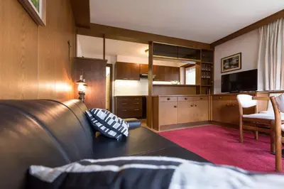 a living room with a couch and a television at Apartments Meisules in Ortisei