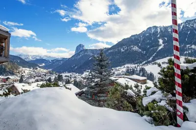 a pile of snow in front of a mountain at Apartments Meisules in Ortisei