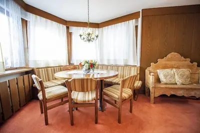 a dining room with a table and chairs at Apartments Meisules in Ortisei