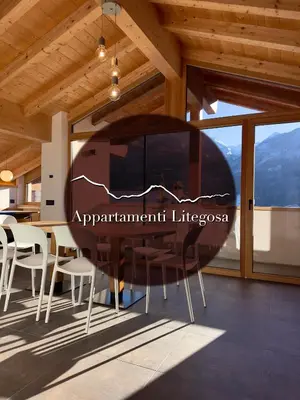 a dining room with a table and chairs at Appartamento LITEGOSA 2 in Panchia