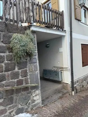 a building with a stairway leading into a building at Casa di Lilly in Moena