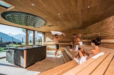 a bedroom with a view of the mountains at Hotel Alpen Tesitin Panorama Wellness Resort in Tesido